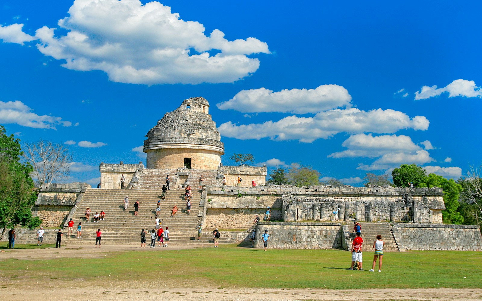 Visitors exploring El Caracol observatory at Chichen Itza, Mexico.
