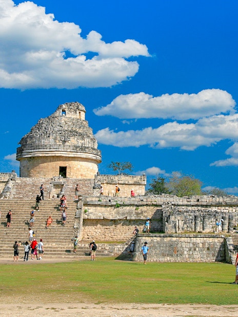 Visitors exploring El Caracol observatory at Chichen Itza, Mexico.