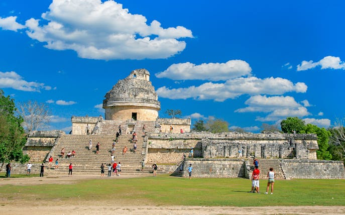 Visitors exploring El Caracol observatory at Chichen Itza, Mexico.