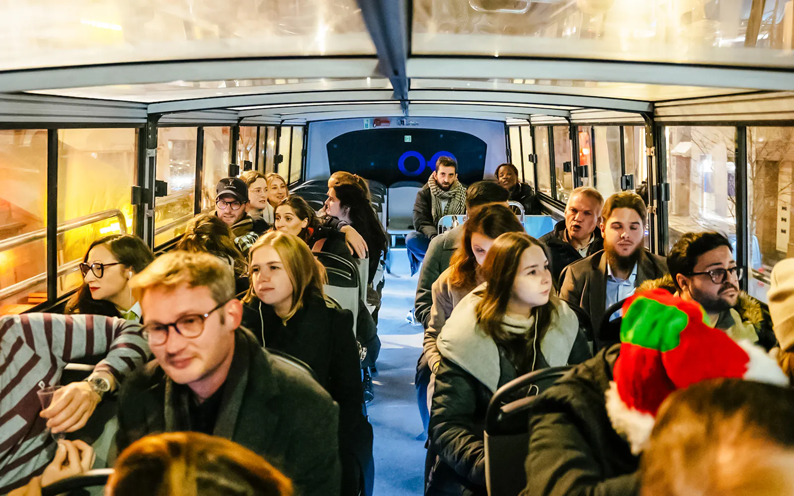 Passengers on a Brussels hop-on hop-off bus during Christmas season.