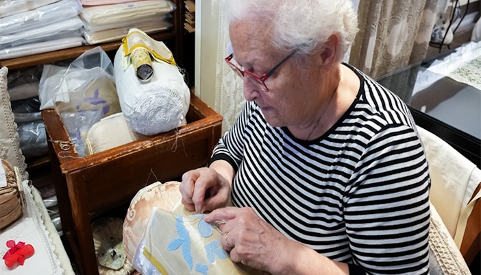 Burano lace school building with colorful facades and canal in Burano, Italy.