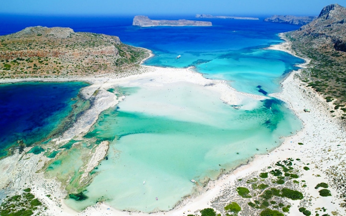 Aerial view of Balos Lagoon's turquoise waters and sandy beaches in Crete, Greece.