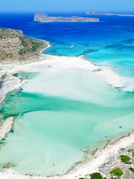 Aerial view of Balos Lagoon's turquoise waters and sandy beaches in Crete, Greece.