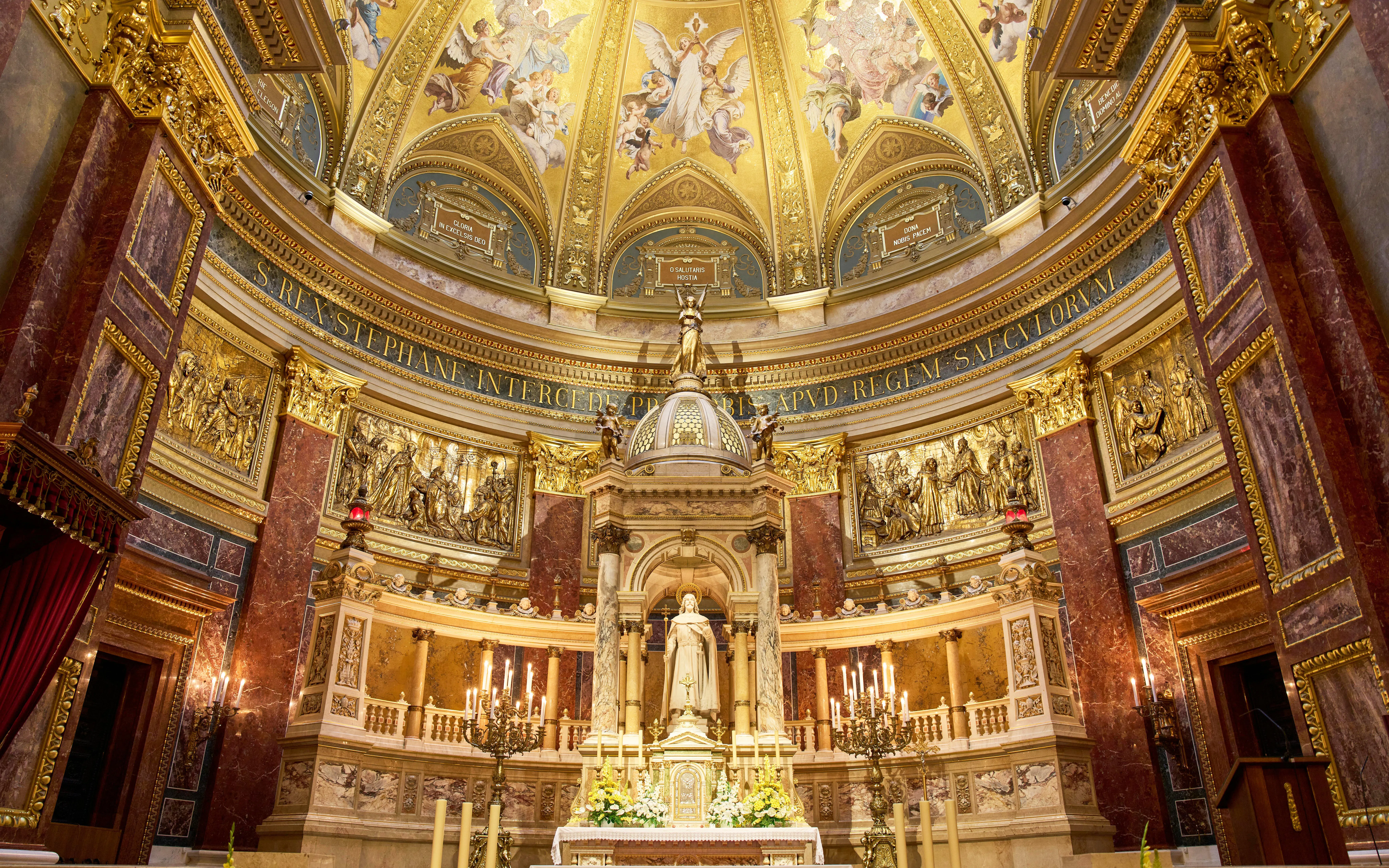 Altar in St. Stephen's Basilica, Budapest, featuring ornate gold detailing and religious statues.