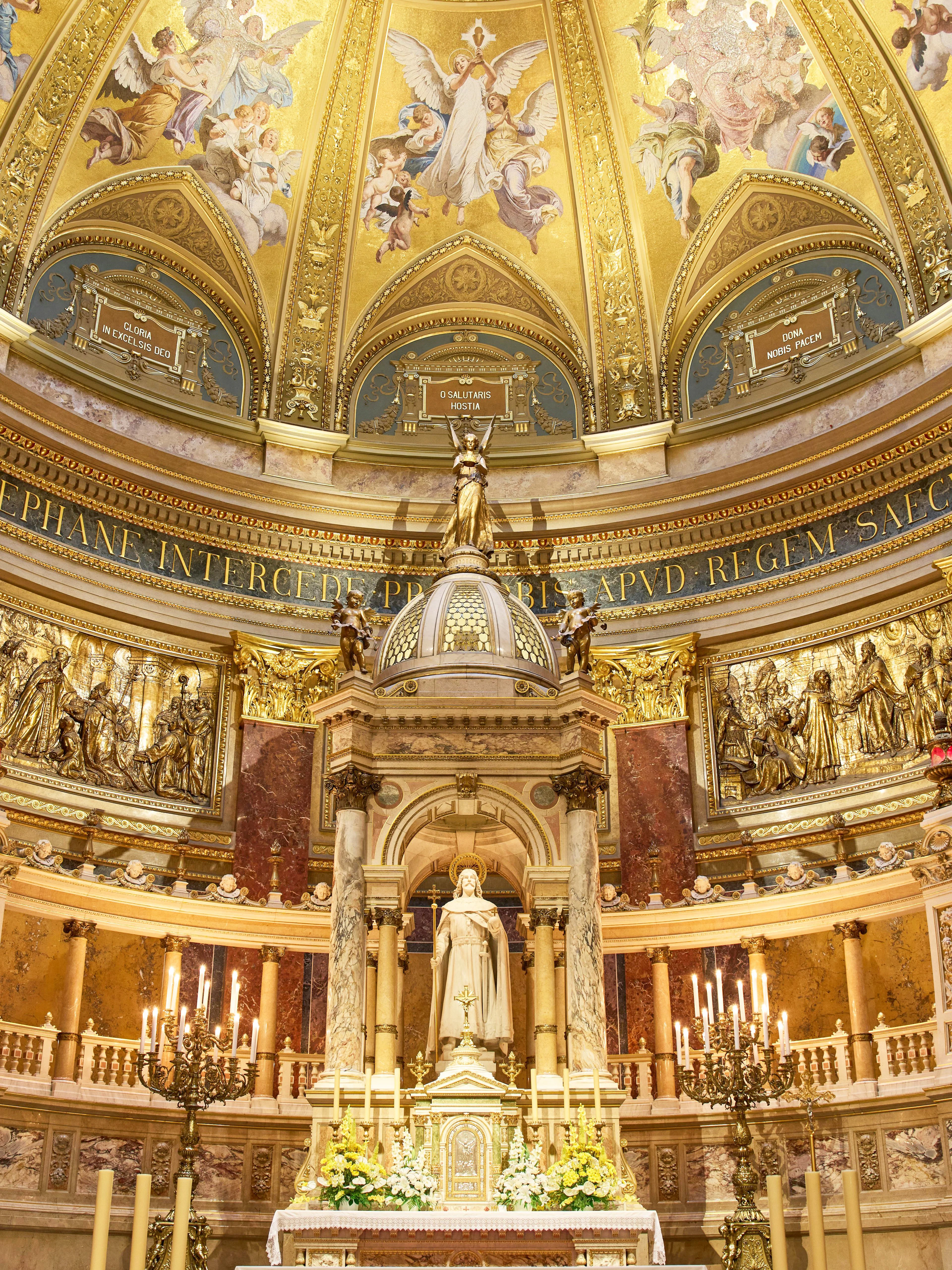 Altar in St. Stephen's Basilica, Budapest, featuring ornate gold detailing and religious statues.