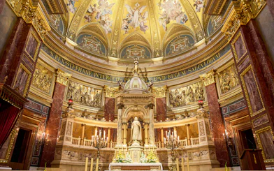 Altar in St. Stephen's Basilica, Budapest, featuring ornate gold detailing and religious statues.