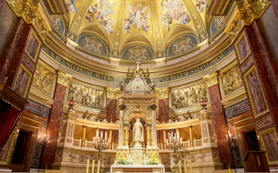Altar in St. Stephen's Basilica, Budapest, featuring ornate gold detailing and religious statues.