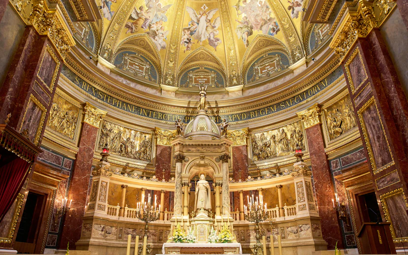 Altar in St. Stephen's Basilica, Budapest, featuring ornate gold detailing and religious statues.