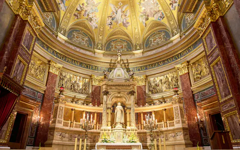 Altar in St. Stephen's Basilica, Budapest, featuring ornate gold detailing and religious statues.