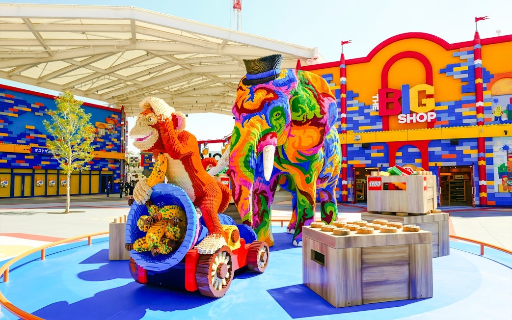 Colorful Lego sculptures of an elephant and monkey at Legoland Japan entrance.