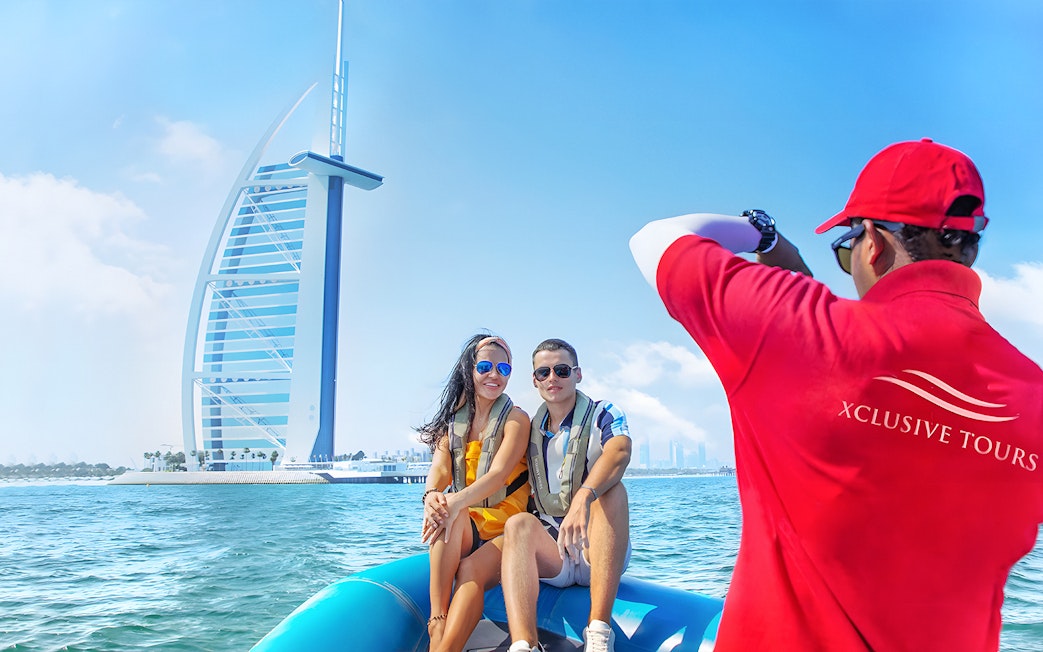Couple on speedboat near Burj Al Arab during Dubai Marina tour.