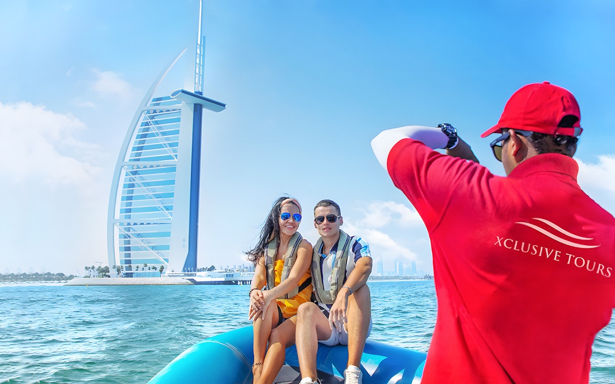 Couple on speedboat near Burj Al Arab during Dubai Marina tour.