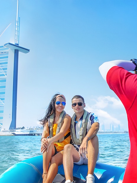 Couple on speedboat near Burj Al Arab during Dubai Marina tour.