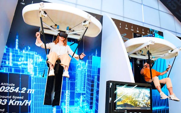 People experiencing the Mahanakhon Skyride in Bangkok with VR headsets.