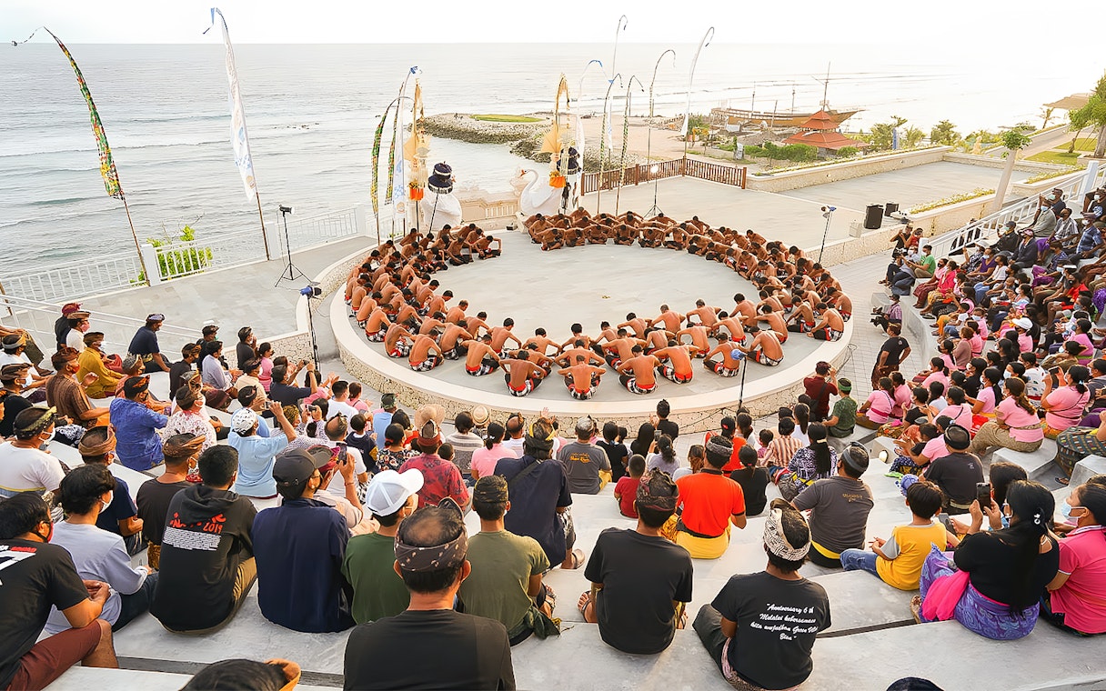Kecak Fire Dance performance in Ubud amphitheater with ocean view.