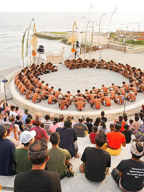 Kecak Fire Dance performance in Ubud amphitheater with ocean view.