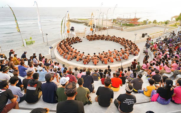 Kecak Fire Dance performance in Ubud amphitheater with ocean view.