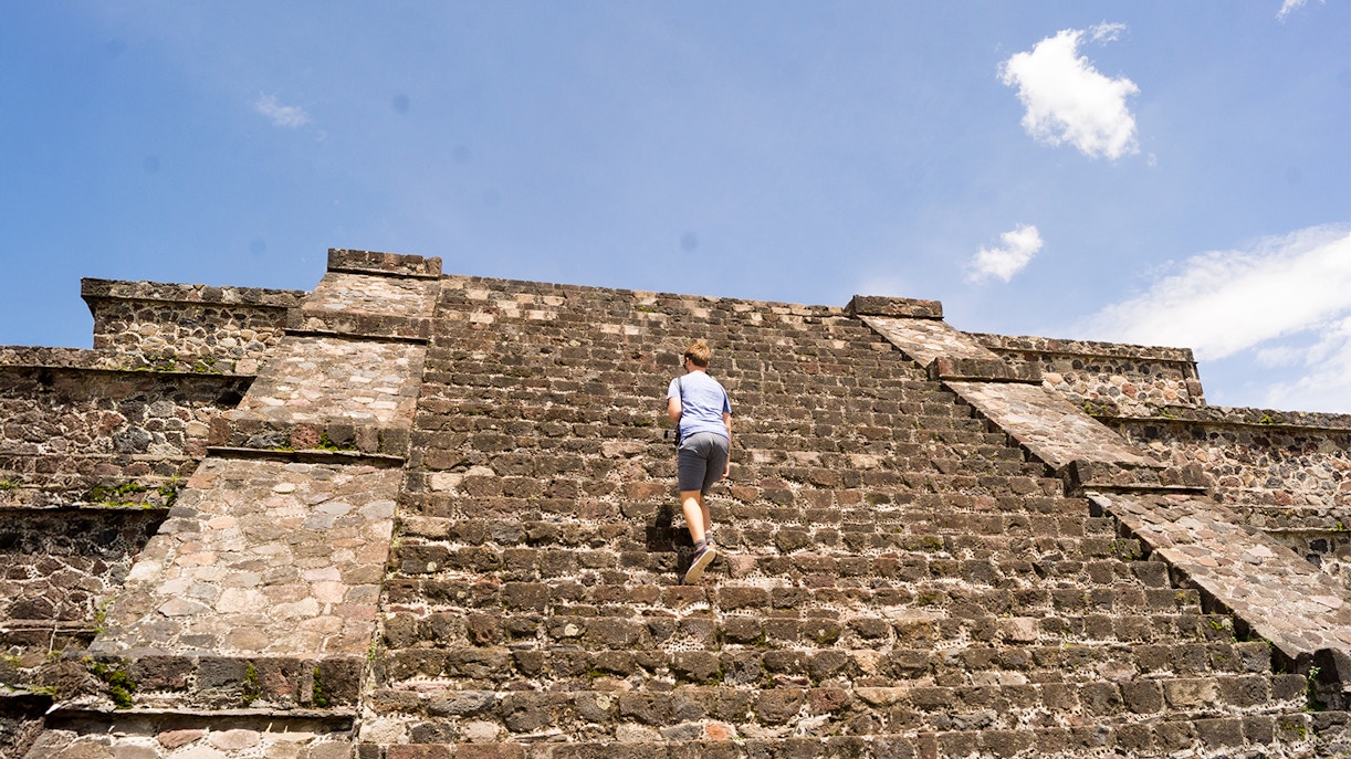 Tourist climbing Pyramid of the Moon at Teotihuacan, Mexico.