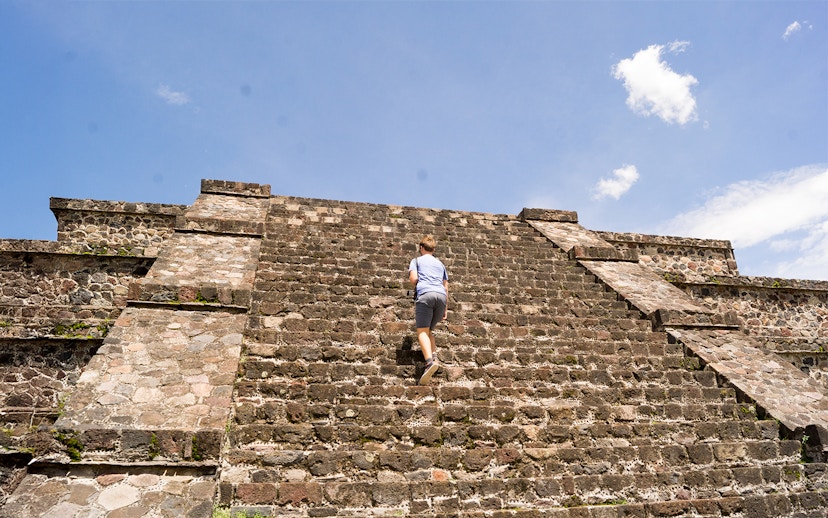 Tourist climbing the Pyramid of the Moon in Teotihuacan, Mexico.