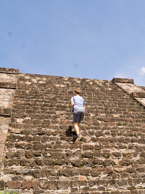 Tourist climbing the Pyramid of the Moon in Teotihuacan, Mexico.