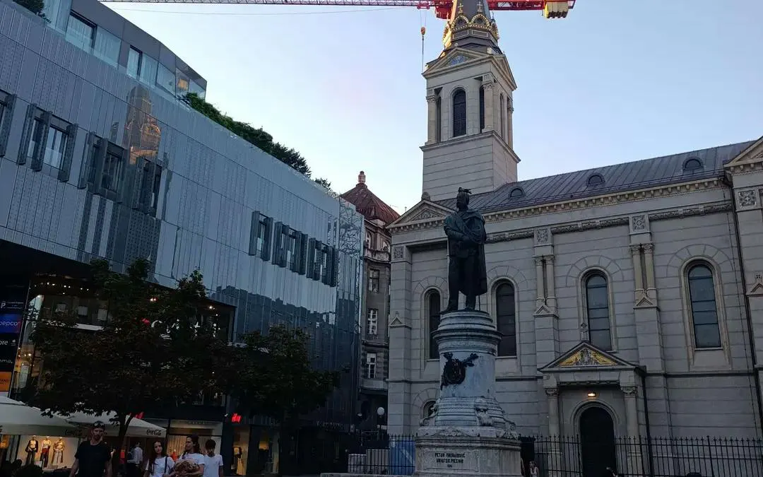Statue of a historical figure in front of a church in Zagreb, part of the self-guided city exploration game.