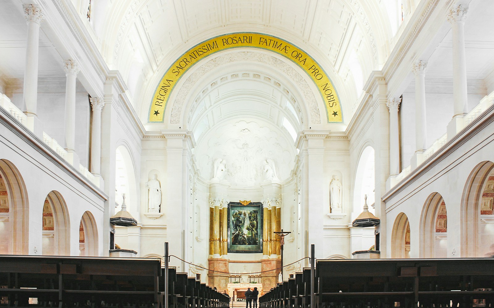 Interior of Fatima Christian Sanctuary in Portugal with altar and arches.