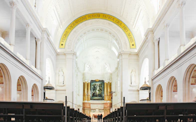 Interior of Fatima Christian Sanctuary in Portugal with altar and arches.