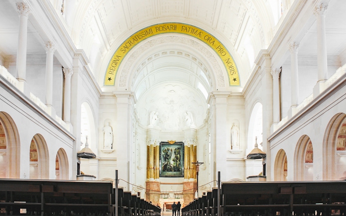 Interior of Fatima Christian Sanctuary in Portugal with altar and arches.