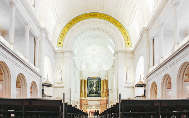 Interior of Fatima Christian Sanctuary in Portugal with altar and arches.