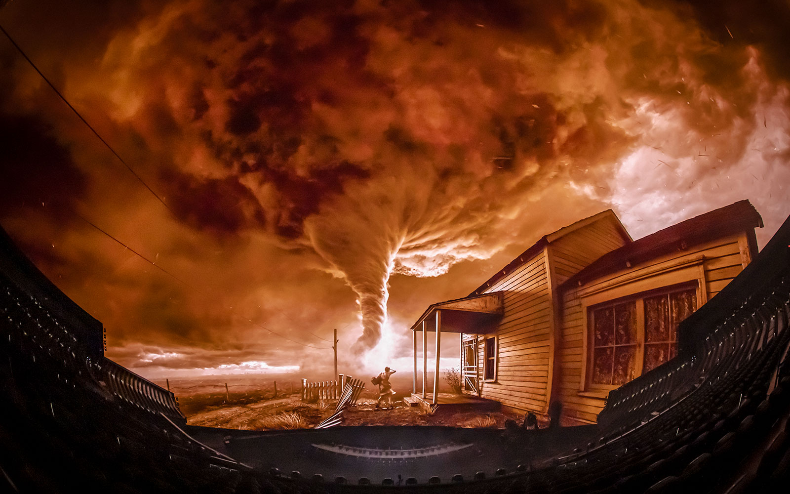 Tornado scene from Wizard of Oz show at Sphere, featuring a farmhouse and swirling clouds.