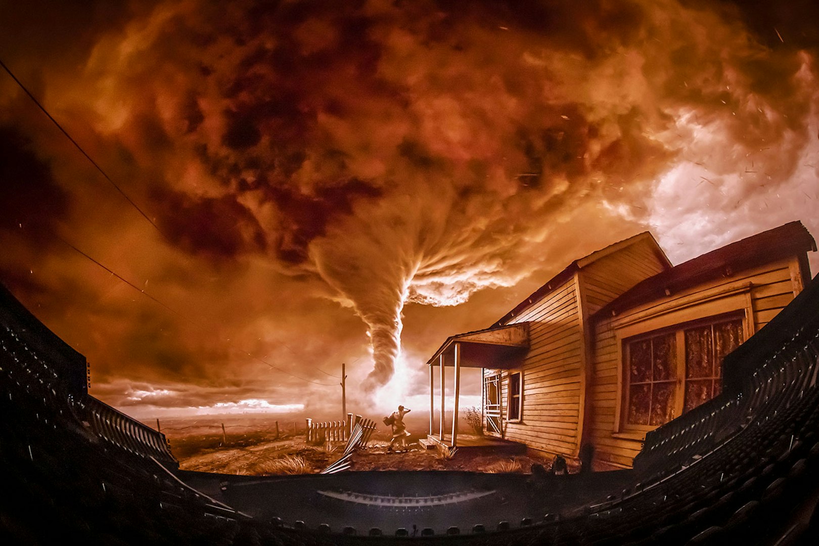 Tornado scene from Wizard of Oz show at Sphere, featuring a farmhouse and swirling clouds.