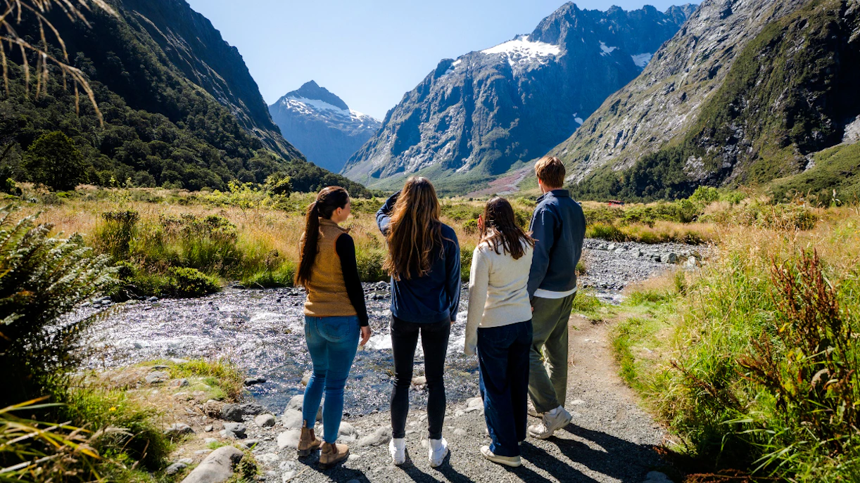 Group exploring Milford Sound landscape on a Queenstown tour.
