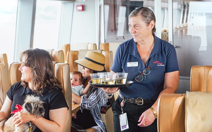 Ferry staff serving drinks to passengers on Seattle to Victoria high-speed ferry.