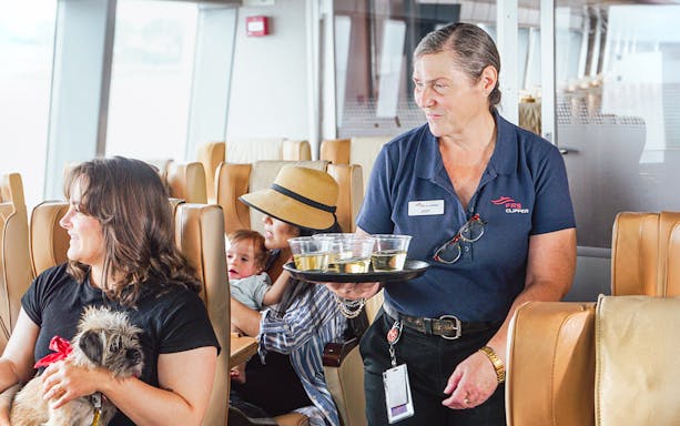 Ferry staff serving drinks to passengers on Seattle to Victoria high-speed ferry.