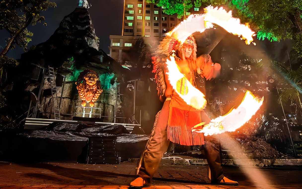 Fire performer with flaming hoops at Sunway Lagoon Night Park, Malaysia.
