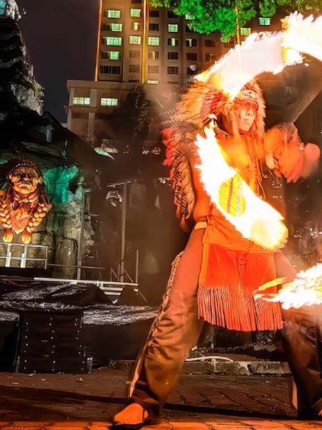 Fire performer with flaming hoops at Sunway Lagoon Night Park, Malaysia.