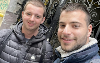 Two people smiling in Budapest's Jewish Quarter during a self-guided city exploration game.