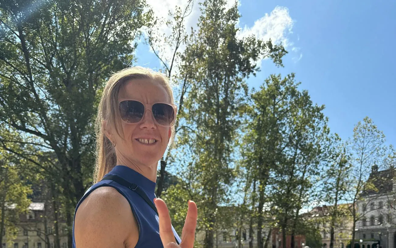 Person enjoying a sunny day in Ljubljana park during a self-guided city exploration game.