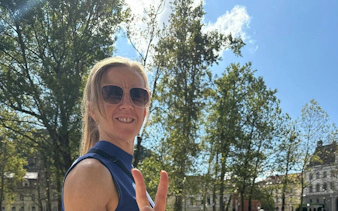 Person enjoying a sunny day in Ljubljana park during a self-guided city exploration game.