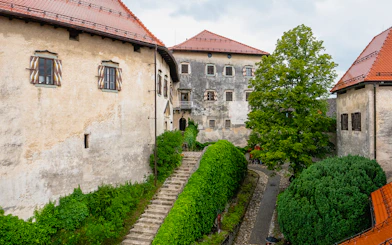 Inner courtyard of Bled Castle in Slovenia with stone path and greenery.