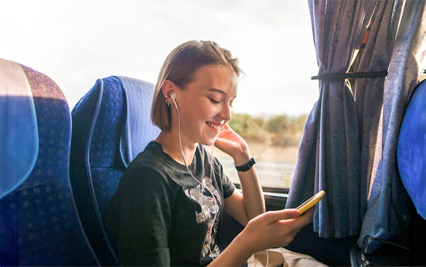 Traveler enjoying a bus ride to Cairo's Tutankhamun Exhibition and Grand Egyptian Museum.