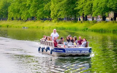 Guests on a motorboat tour in Auwald, Leipzig, enjoying the scenic river view.