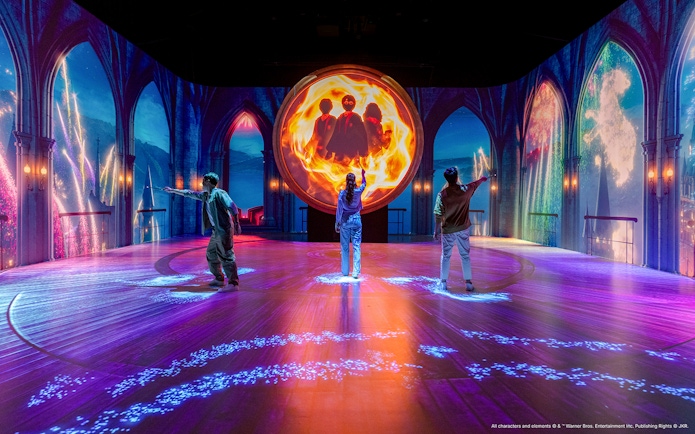 Visitors interact with magical projections at the Harry Potter Visions of Magic exhibit.