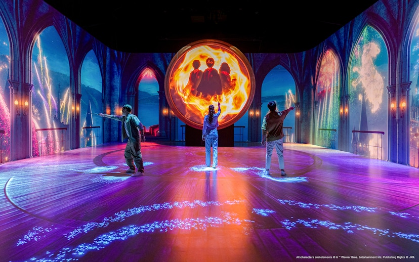 Visitors interact with magical projections at the Harry Potter Visions of Magic exhibit.