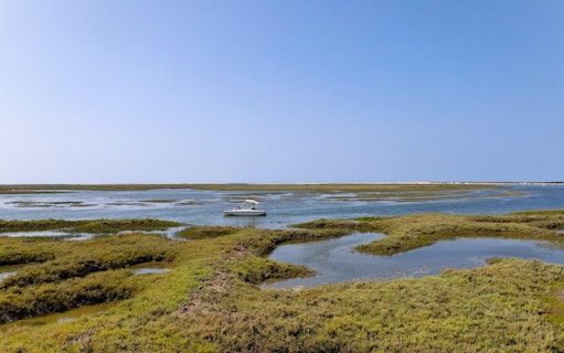 Eco boat navigating Ria Formosa wetlands on Algarve tour from Faro.
