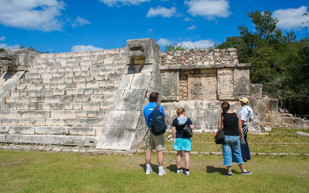 Tourists exploring the ancient ruins at Chichen Itza, Mexico.
