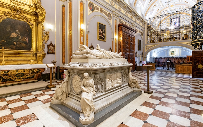 Tomb inside Royal College of Noble Maidens, Toledo, with ornate sculptures and paintings.