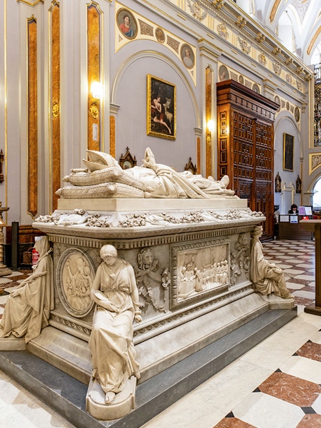 Tomb inside Royal College of Noble Maidens, Toledo, with ornate sculptures and paintings.