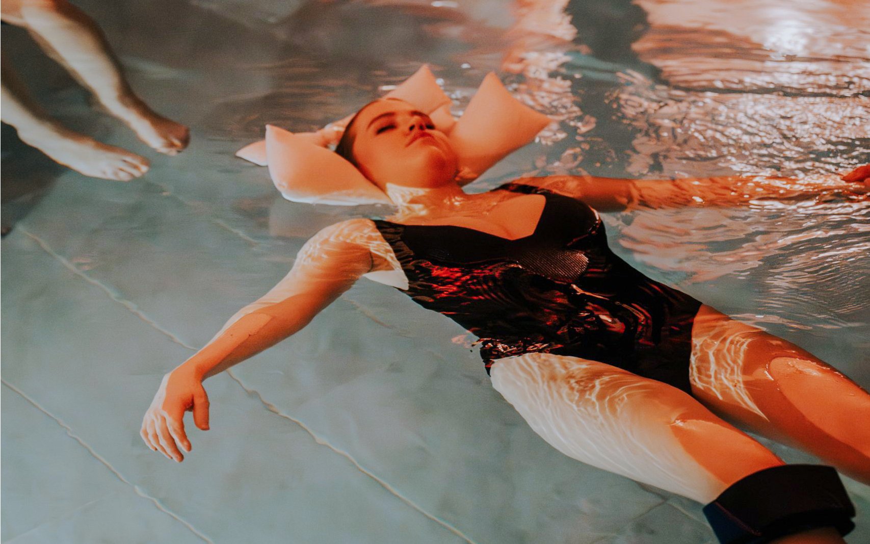 Person relaxing in a pool at Mandala Day Spa.