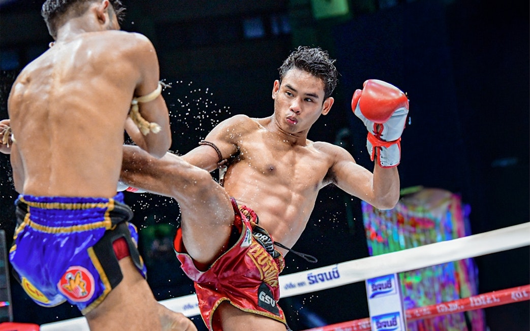 Muay Thai fighters in action at Rajadamnern Boxing Stadium, Bangkok.